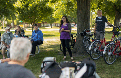 Tiffany Tononi, grant coordinator for the Otto Schoitz Foundation, speaks at Washington Park, where project partners addressed the University of Iowa visitors and community representatives.