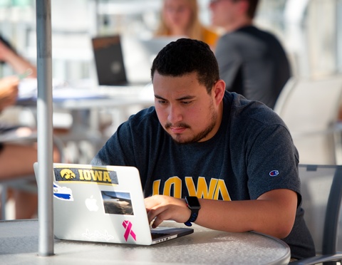 UI student using laptop outdoors