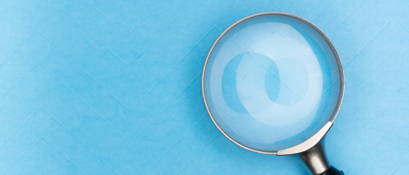 magnifying glass against a blue background