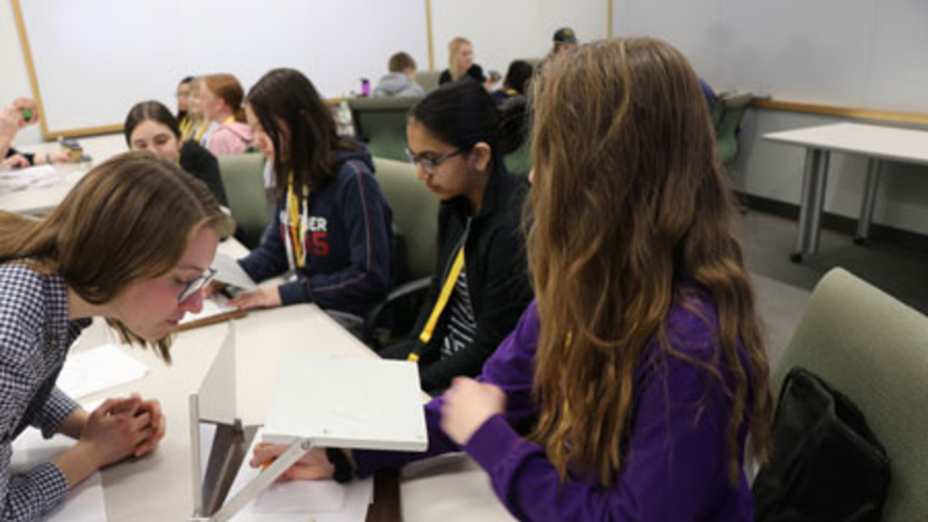 Neuroscience PhD scholars worked with students on a tracing activity focused on motor memory.